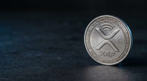 Physical silver coin engraved with the XRP Ripple symbol