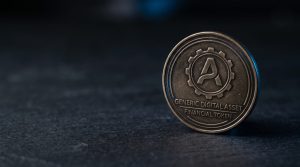 A physical silver Polkadot coin with clean geometric engraving on a neutral dark surface
