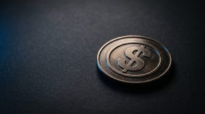 Physical coin engraved with XRP symbol on neutral surface