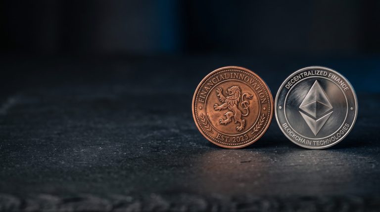 Two physical coins of different colours side-by-side on a neutral dark surface