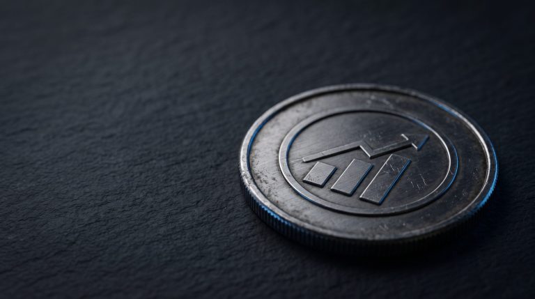 Physical silver coin with engraved Solana symbol on dark surface