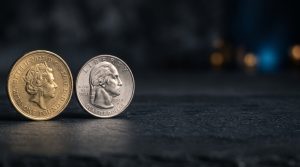 Two physical coins of different colors side-by-side on a neutral dark surface